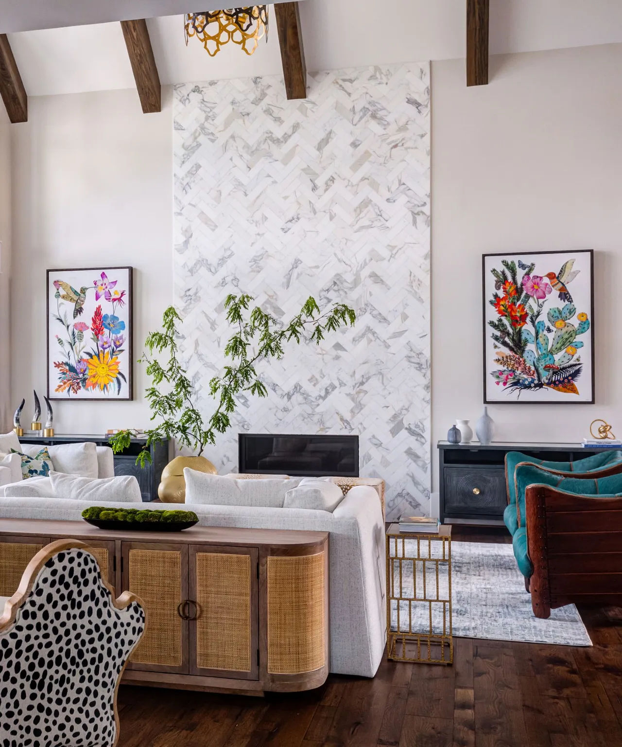A pale sofa sits beside a woven-front sideboard beneath a patterned fireplace wall.