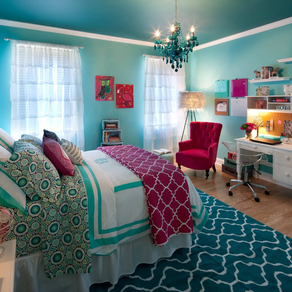 Turquoise teen bedroom with a white desk, clear study chair and magenta armchair
