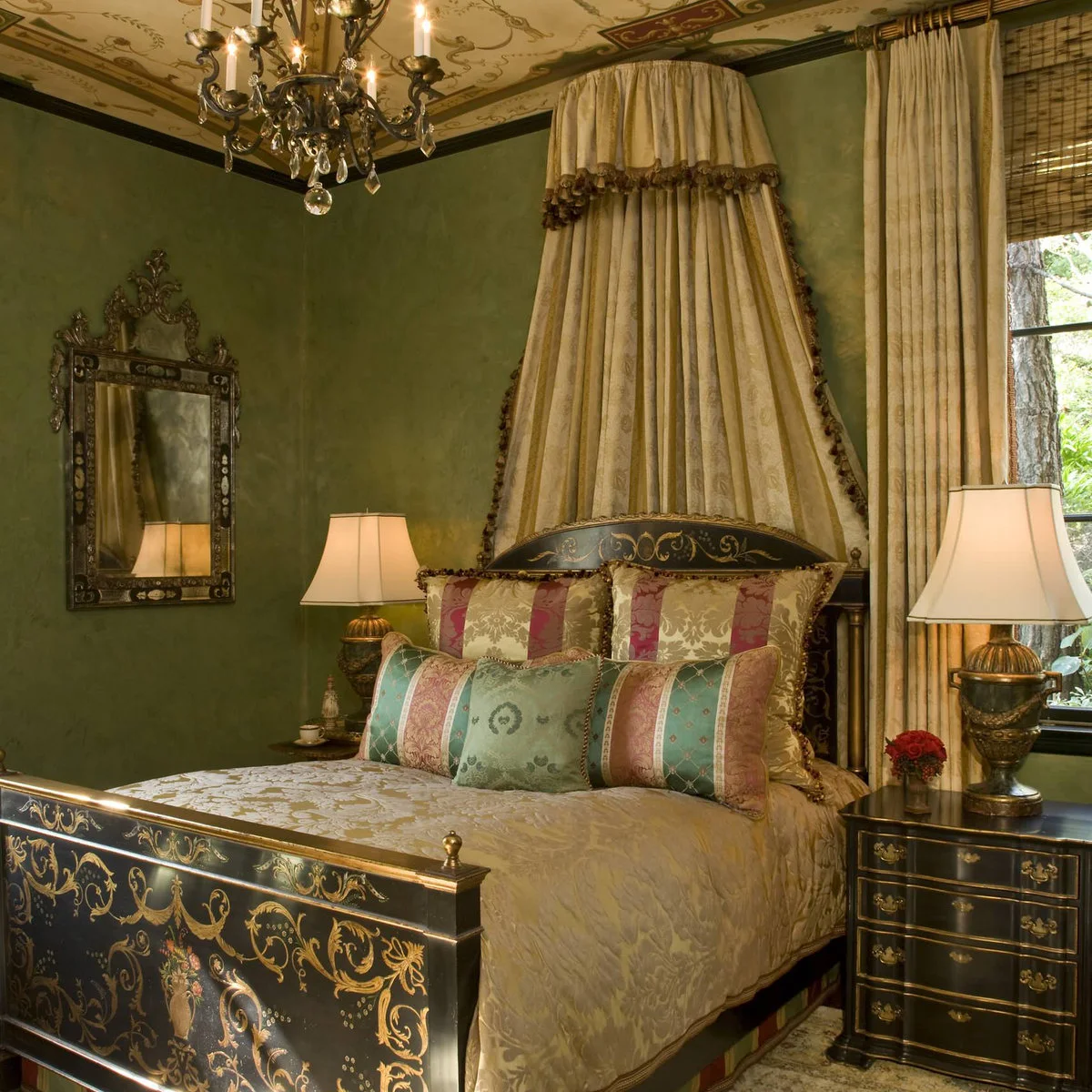 Green bedroom with black and gold decorated bed, draped headboard and patterned ceiling