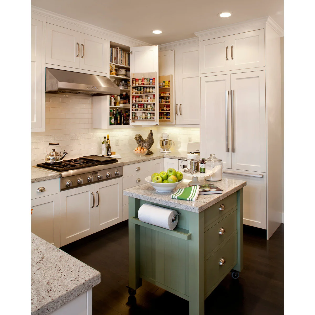Compact green kitchen cart with drawers, casters and an end-mounted paper towel holder