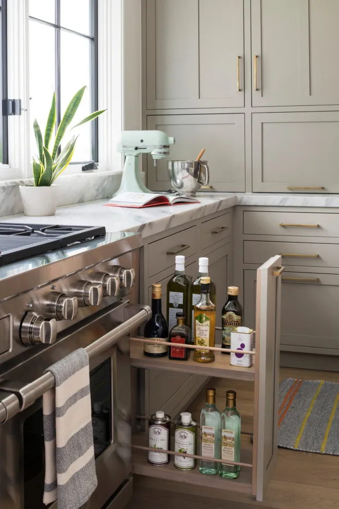 A beige cabinet beside the range opens to reveal narrow pull-out shelves
