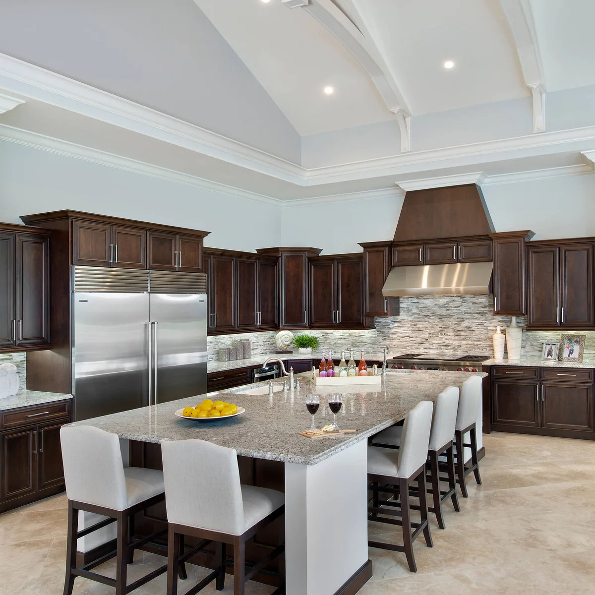 Pale full-backed kitchen stools with dark legs arranged along two sides of a large island