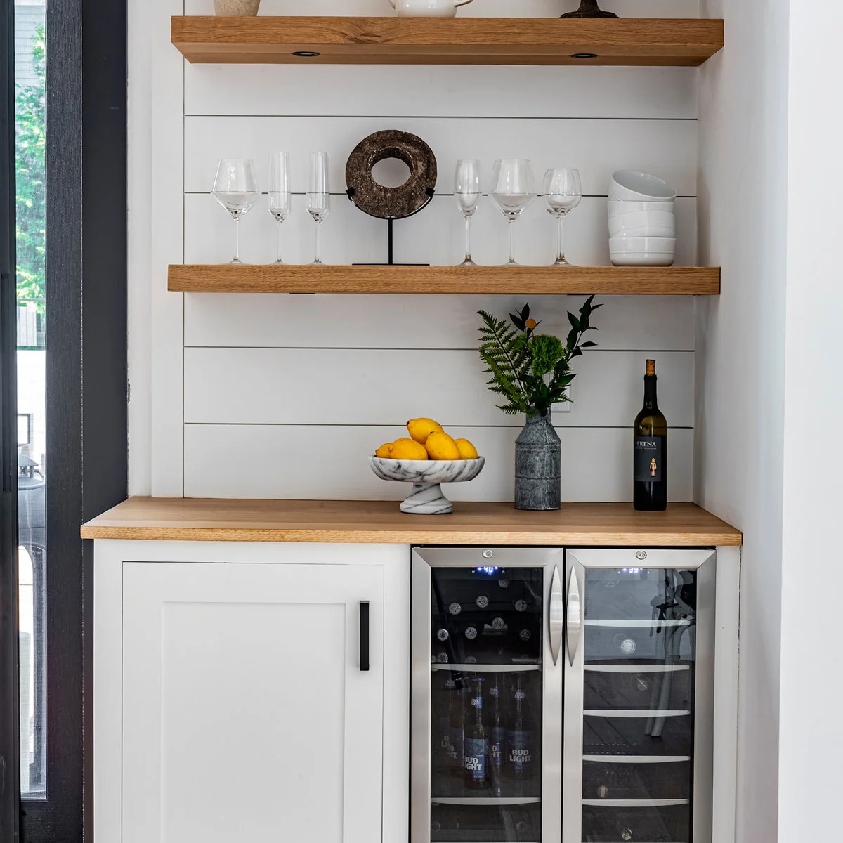 White mini bar base with wood counter and shelves, horizontal white boards and two-zone beverage refrigerator