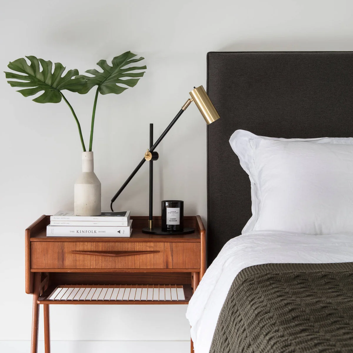 Wooden nightstand with single drawer, slatted lower shelf and adjustable black-and-gold lamp