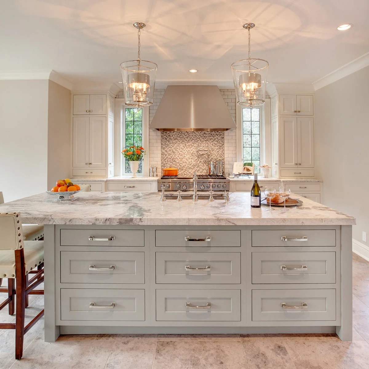 Gray kitchen island with several shallow and deep drawers facing its broad end