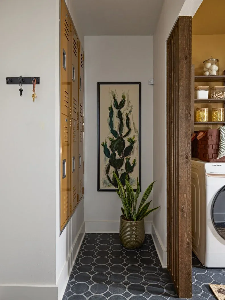 Mustard-colored lockers recessed beside a wooden slat divider and laundry appliances.