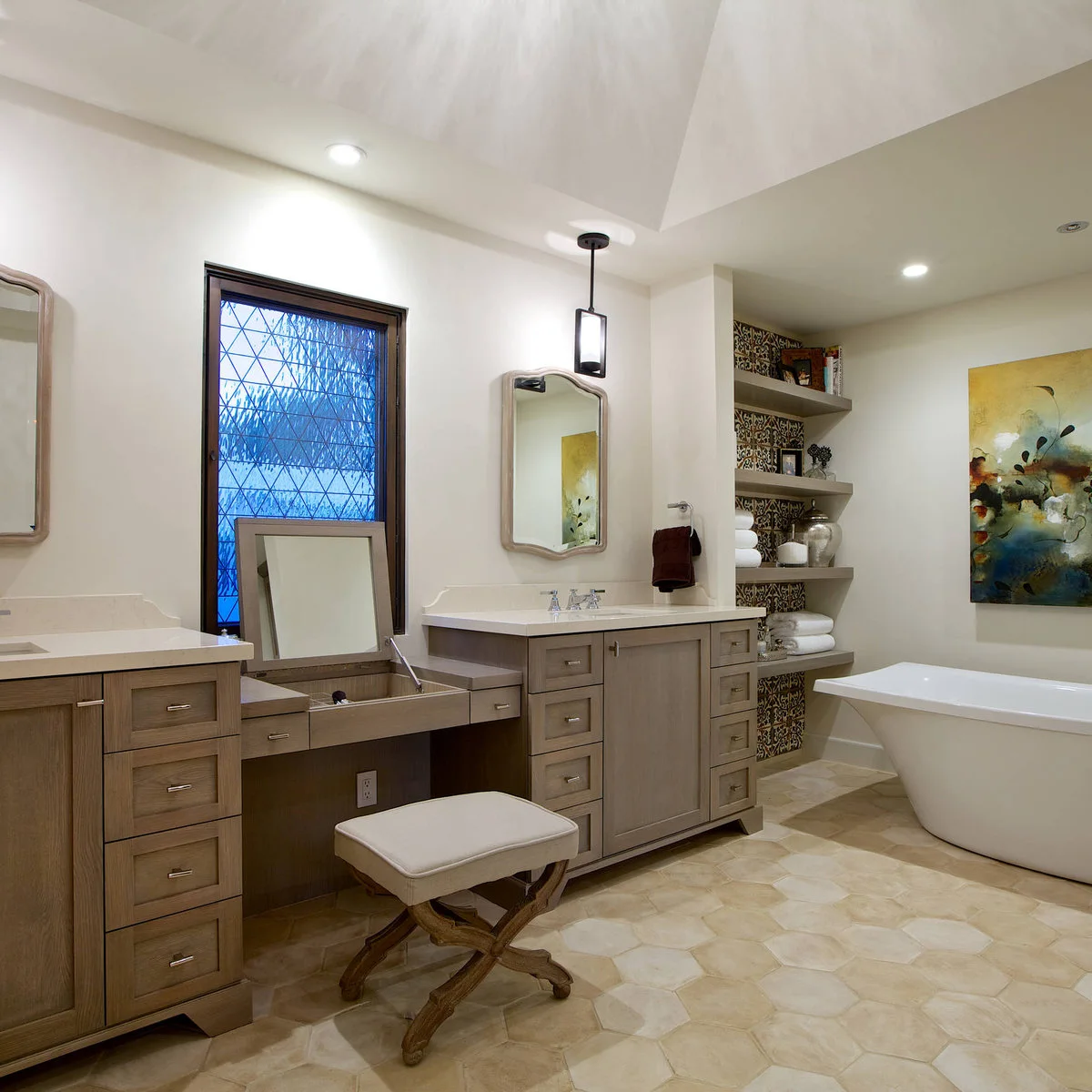 Bathroom with a pale hexagonal floor, wood-toned vanities and patterned tile behind open shelves