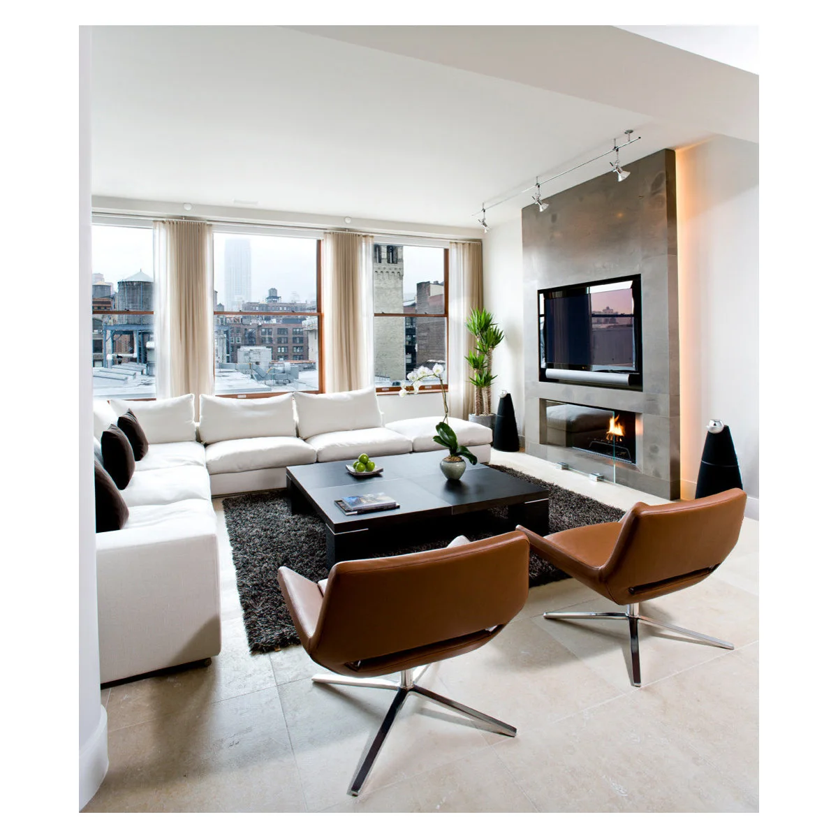 TV and fireplace set in a projecting gray panel with a warm glow along its edge