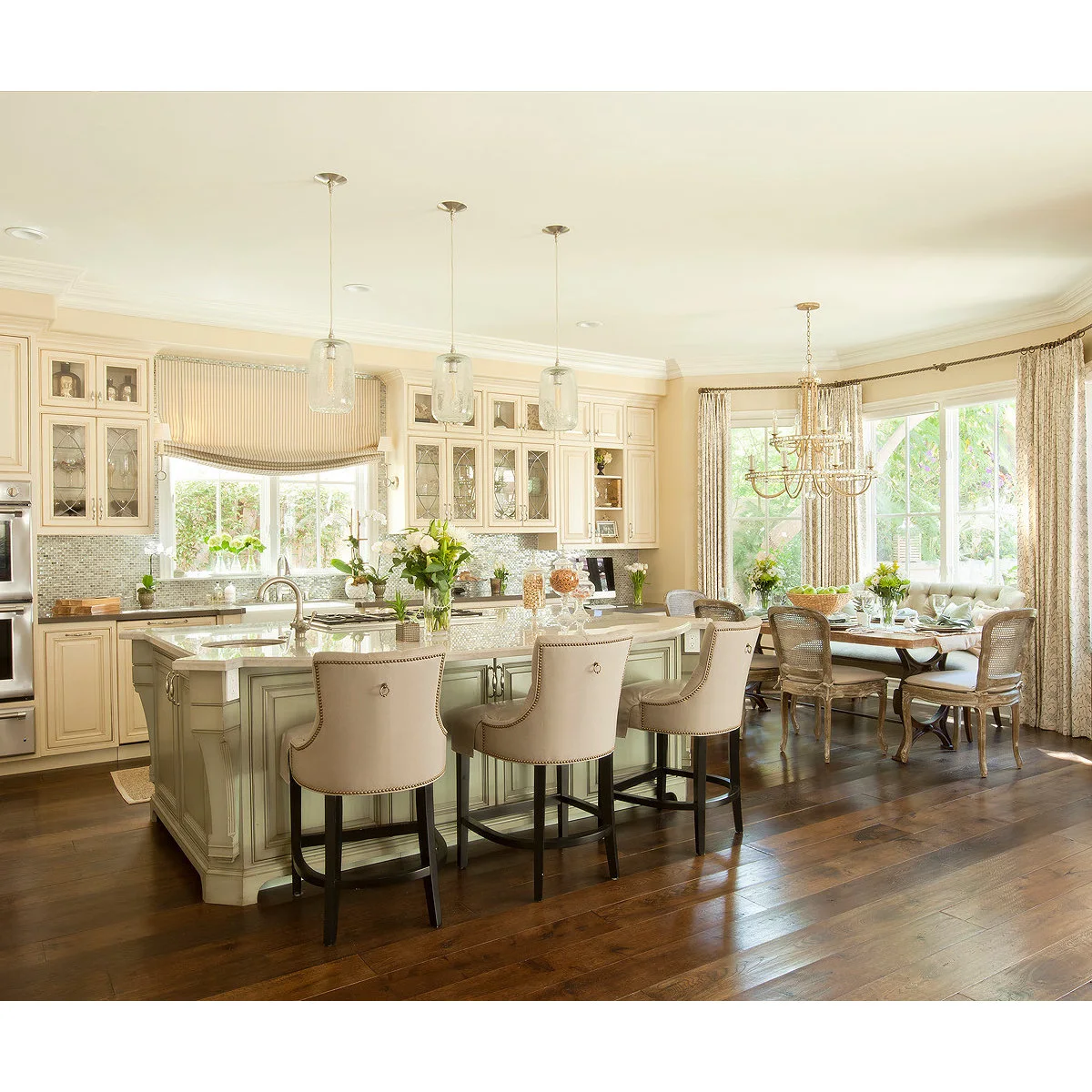 Striped sink-window shade and patterned dining curtains in a cream kitchen
