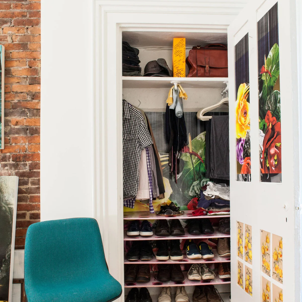Compact open closet with hanging shirts, folded clothes, a high bag shelf and several shallow shoe shelves