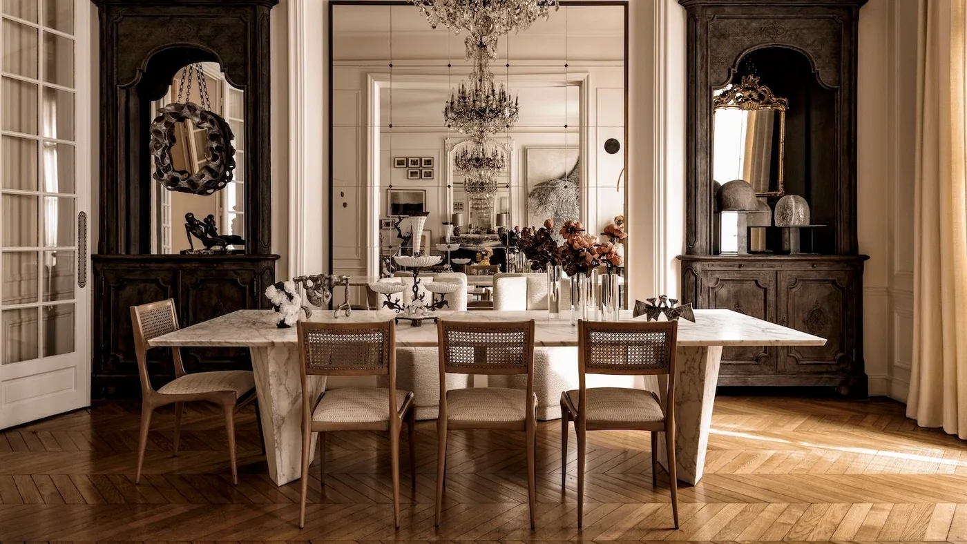 Dining room with a pale rectangular table, woven-back wood chairs, large dark display cupboards, mirrored wall and pale curtains