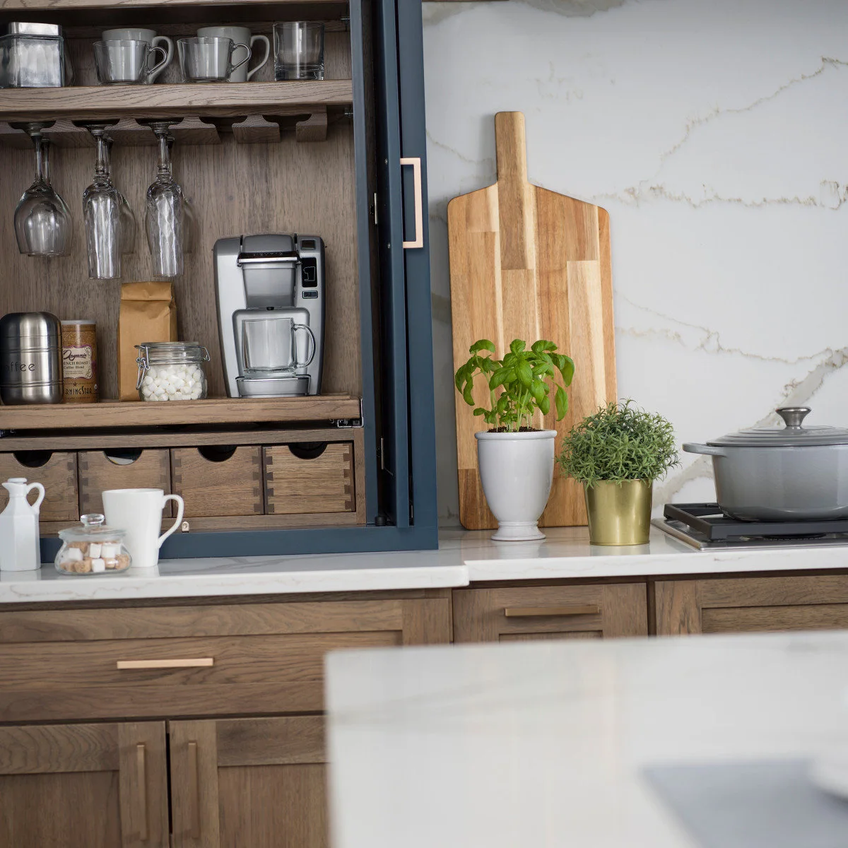 Blue-framed wooden coffee cupboard with small drawers, mugs and a pod machine